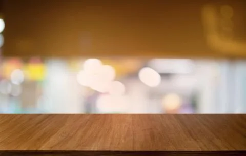 Empty dark wooden table in front of abstract blurred bokeh background of rest Stock Photos