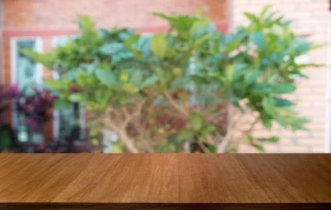 Empty dark wooden table in front of abstract blurred bokeh background of rest Stock Photos
