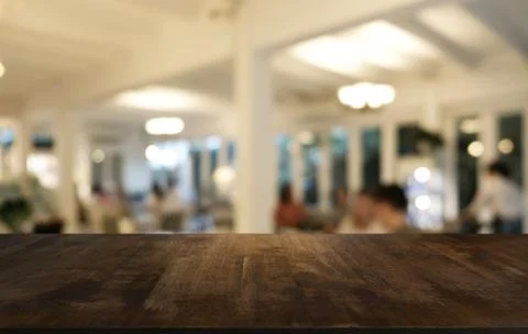 Empty dark wooden table in front of abstract blurred bokeh background of rest Stock Photos