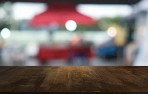 Empty dark wooden table in front of abstract blurred bokeh background of rest Stock Photos
