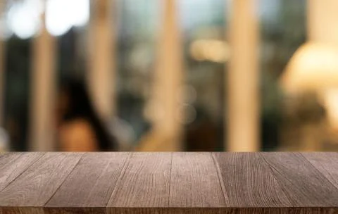 Empty dark wooden table in front of abstract blurred bokeh background of rest Stock Photos