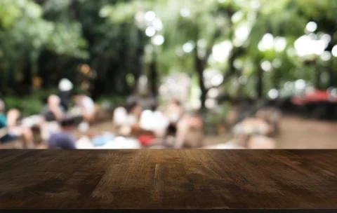 Empty dark wooden table in front of abstract blurred bokeh background of rest Stock Photos