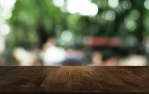 Empty dark wooden table in front of abstract blurred bokeh background of rest Stock Photos
