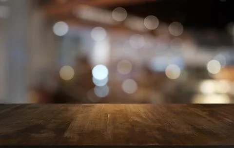 Empty dark wooden table in front of abstract blurred bokeh background of rest Foto stock