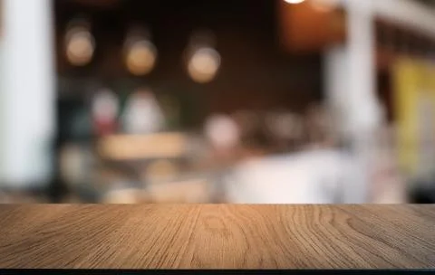 Empty dark wooden table in front of abstract blurred bokeh background of rest Stock Photos