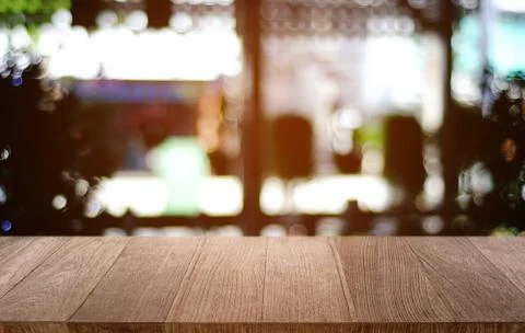 Empty dark wooden table in front of abstract blurred bokeh background of rest Stock Photos