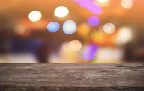 Empty dark wooden table in front of abstract blurred bokeh background of rest Stock Photos