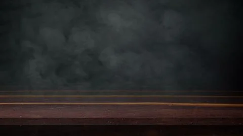 An empty dark wooden table surface against a moody, smoky background, perfe.. Stock Photos