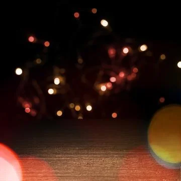 Empty dark wooden table surface with vibrant blurred bokeh lights backgroun.. Stock Photos