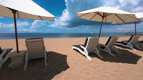 Empty day beds on a beautiful beach with clear blue sky Stock Footage 237934701