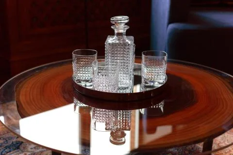 Empty decanter for brandy and three square glasses Stock Photos