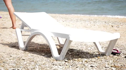 An empty deck chair on the beach Stock Footage 54928365