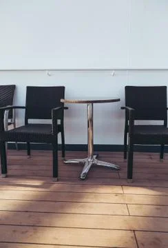 Empty deck chairs and a table on a cruise ship waiting for some one to come a Foto stock