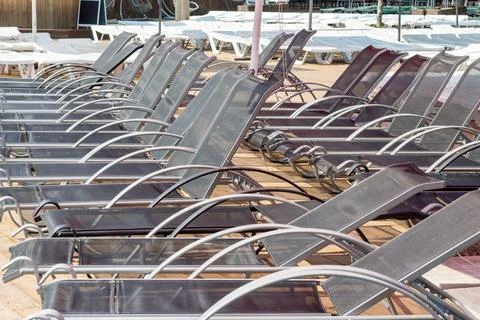 Empty deck chairs on the beach. Failure, tourist season crisis due to quarant Stock Photos