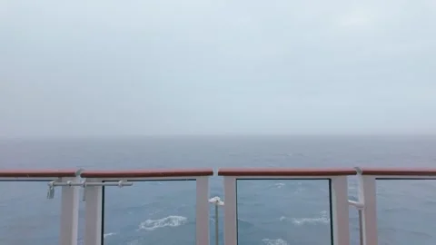 Empty deck chairs on a cruise ship under overcast skies during a storm Stock Footage 317331891