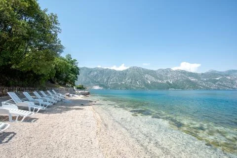 Empty deck chairs on an empty beach, Montenegro Kotor bay Stock Photos