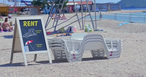Empty deck chairs on the half-empty beach. Stock Footage 133086379