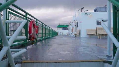 Empty Deck of Ferry Boat Sailing Under Dramatic Clouds on Rainy Day Stock Footage 236920436