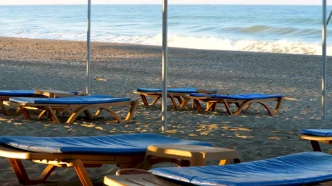 Empty deckchairs on sandy beach during coronavirus covid-19 lockdown Stock Footage 173567364