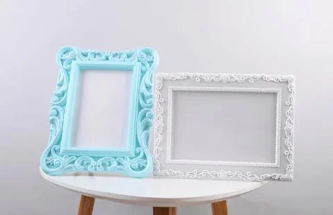 Empty decorative picture frames on a small table Stock Photos
