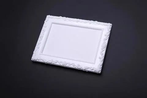 Empty decorative white picture frame on black background Foto stock