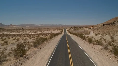Empty desert road - drone flying forward Stock Footage 107879553