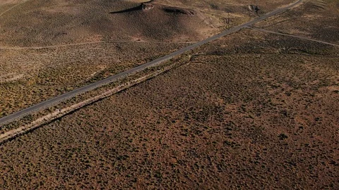 Empty Desert Road in Nevada Desert with Mining Remains on Hill - Aerial Drone Video stock 114738046