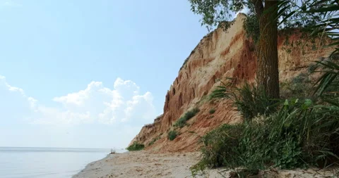 Empty desert sand, wild beach. Exotic sea, ocean water, sandy cliff, rocky hill Stock Footage 170617456