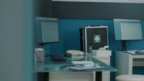 Empty desk in doctors office with computer and medical instruments 스톡 동영상 169789389