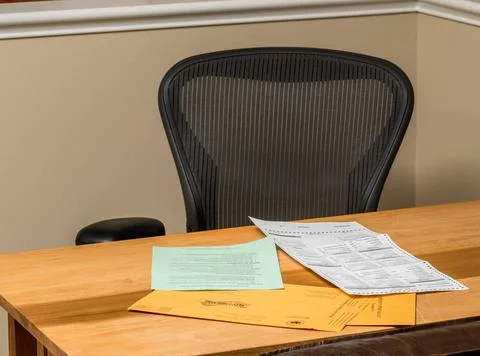Empty desk at home with the paperwork for completing absentee voting ballo... Stock-Fotos