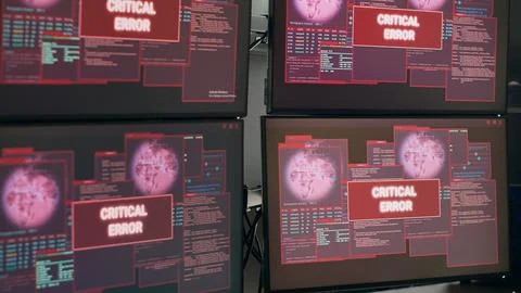 Empty desk with multiple monitors showing system crash warning 写真素材