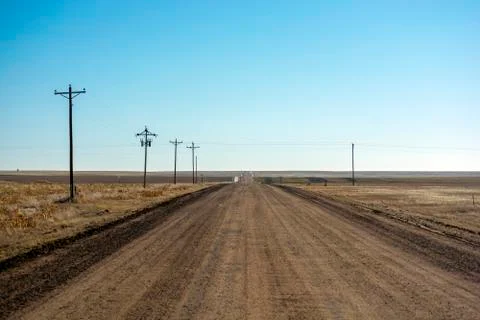 Empty Desolate Rural Dirt Road on a Sunny Day Stock Photos