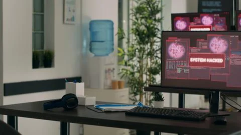 Empty developing office with critical error message flashing on screens Foto stock