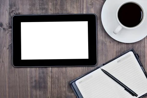 Empty digital tablet with notebook and coffee cup Stock Photos