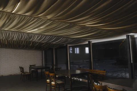 Empty dining area with gold fabric ceiling at night Stock Photos