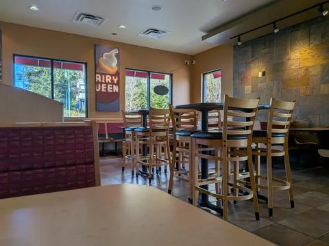 Empty dining area inside a Dairy Queen restaurant with bright windows Photos