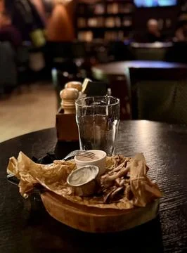 An Empty Dining Plate that has Leftover Food and Beverages Resting on a Table Stock Photos