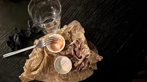 An Empty Dining Plate that has Leftover Food and Beverages Resting on a Table Stock Photos