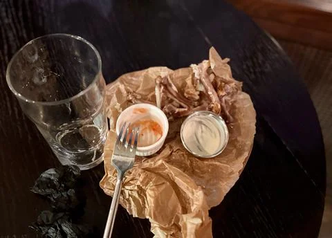 An Empty Dining Plate that has Leftover Food and Beverages Resting on a Table Stock Photos