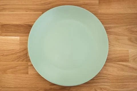 Empty dining plate on oakwood table, top view Stock Photos