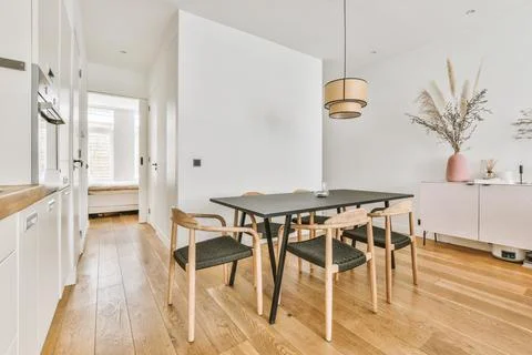 Empty dining room near kitchen Stock Photos