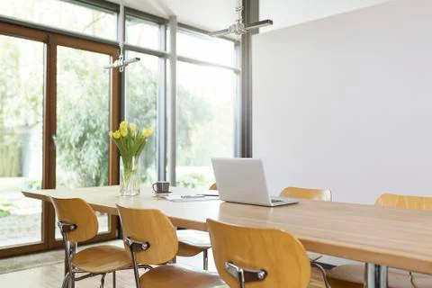 Empty dining room table with laptop Stock Photos