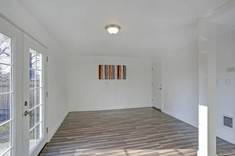 Empty dining room with tiled floor. Pure white walls make the room spacious a Stock Photos