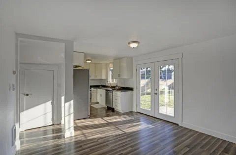 Empty dining room with tiled floor. Pure white walls make the room spacious a Stock Photos