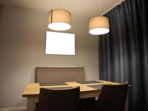 Empty Dining Table with Chairs and an Blank Framed Picture Stock Photos