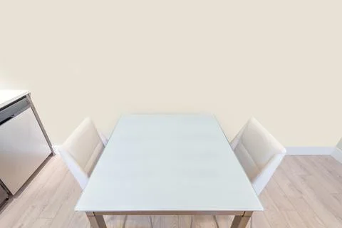 An empty dining table in empty room. Modern dining room in luxury house. Stock Photos