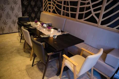 Empty dining table in illuminated restaurant Stock Photos