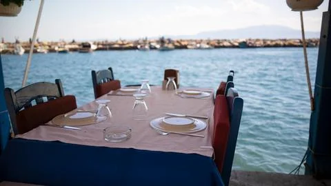 Empty dining table by the sea. blue seaside restaurant Stock Photos