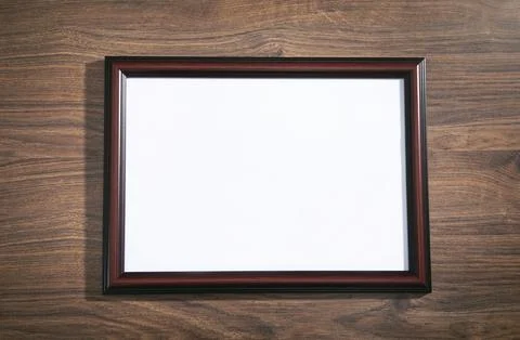 Empty diploma or certificate frame on the table. Stock Photos