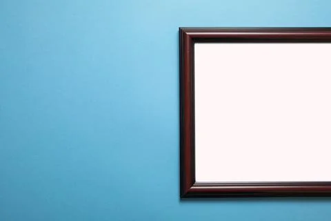 Empty diploma or certificate frame on the blue background. Stock Photos